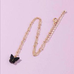 Black butterfly gold tone necklace